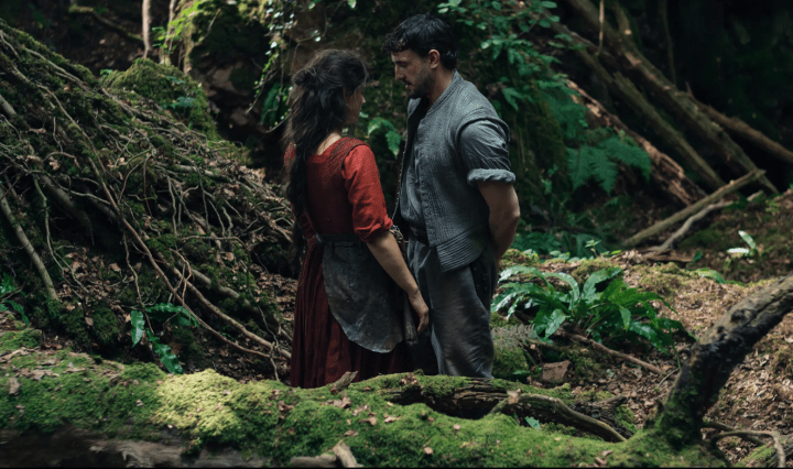 Agnes Hathaway and William Shakespeare stand near each other in a forest.