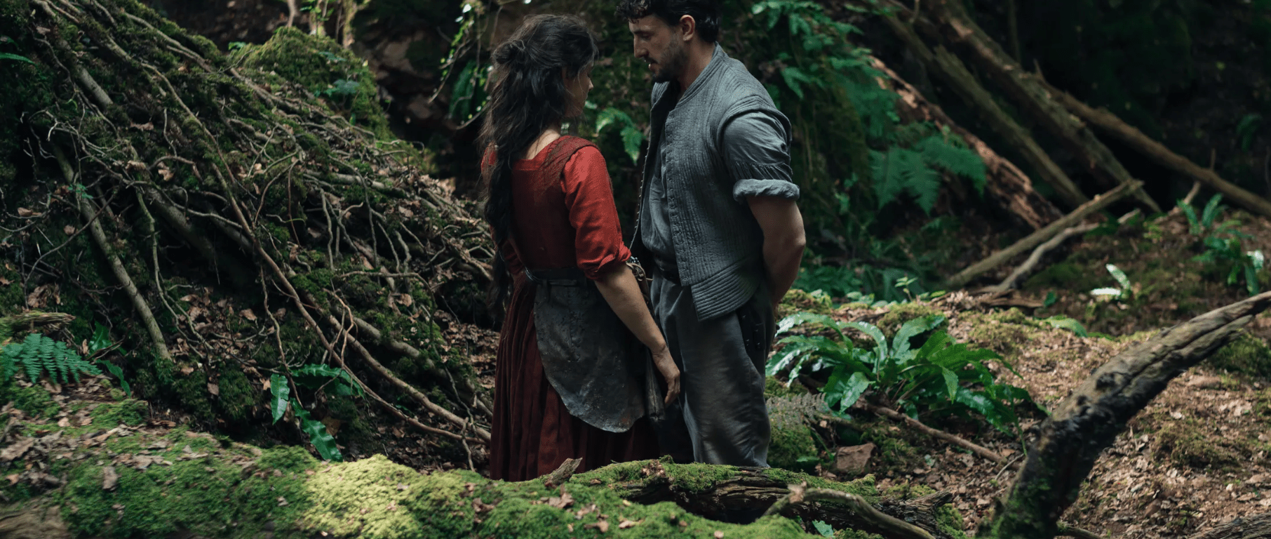 Agnes Hathaway and William Shakespeare stand near each other in a forest.